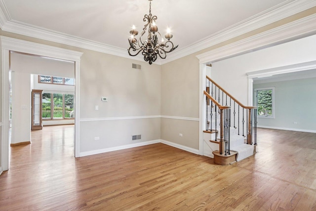 641 Mason Ln, Lake In The Hills, IL 60156 - unfurnished room with plenty of natural light, a chandelier, light wood-style floors, stairway, and ornamental molding