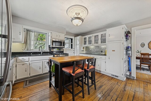 861 Hill Ave, Glen Ellyn, IL 60137 - kitchen with appliances with stainless steel finishes, butcher block countertops, white cabinets, and dark wood-style floors