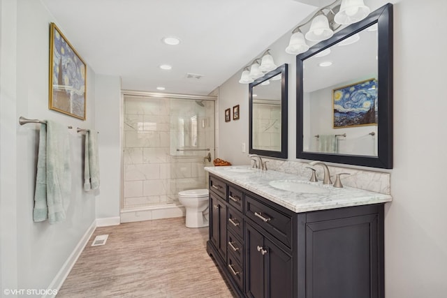 20 Brook Ln, Palos Park, IL 60464 - bathroom featuring double vanity, wood finished floors, a shower stall, and recessed lighting