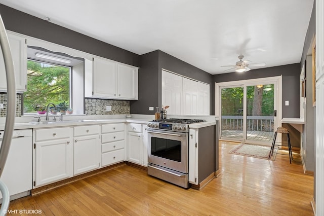 20 Brook Ln, Palos Park, IL 60464 - kitchen with stainless steel range with gas cooktop, white dishwasher, light countertops, light wood finished floors, and white cabinets