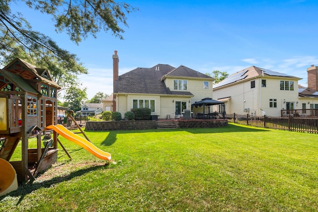 7715 Virginia Ct, Willowbrook, IL 60527 - rear view of house with a gazebo, a playground, and a chimney