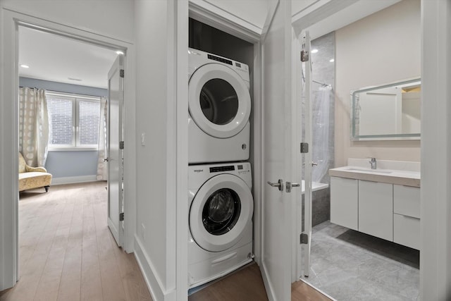 6223 S Ellis Ave, Chicago, IL 60637 - washroom with stacked washing machine and dryer and light wood-style flooring