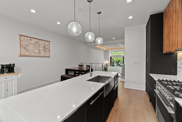 6223 S Ellis Ave, Chicago, IL 60637 - kitchen featuring dark cabinets, high end stainless steel range oven, light wood-style flooring, recessed lighting, and an island with sink