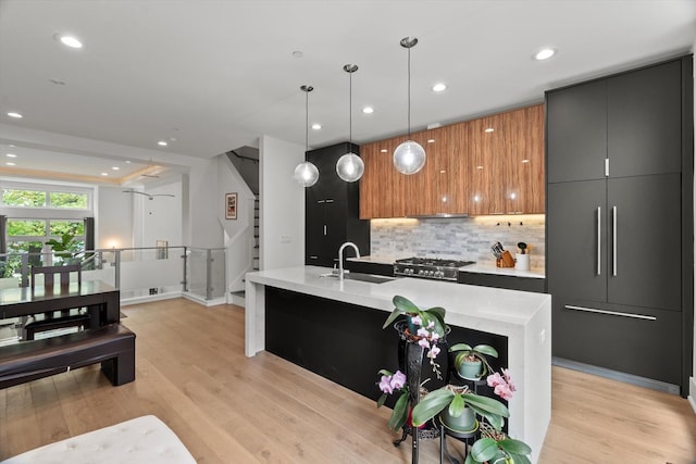 6223 S Ellis Ave, Chicago, IL 60637 - kitchen with modern cabinets, backsplash, recessed lighting, light wood-style flooring, and decorative light fixtures