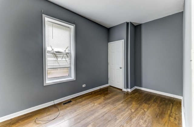 6601 S St Lawrence Ave, Chicago, IL 60637 - spare room with dark wood-style flooring