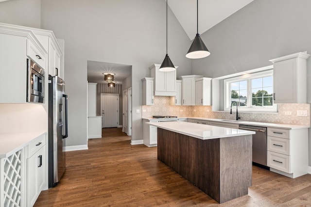 9724 Folkers Dr, Frankfort, IL 60423 - kitchen with appliances with stainless steel finishes, high vaulted ceiling, light countertops, white cabinetry, and backsplash