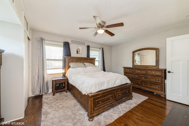 247 Tioga Ave, Bensenville, IL 60106 - bedroom featuring wood finished floors, multiple windows, ceiling fan, and a textured ceiling
