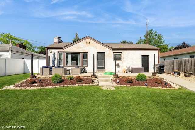 247 Tioga Ave, Bensenville, IL 60106 - ranch-style home with outdoor lounge area, a fenced backyard, a patio, and a chimney