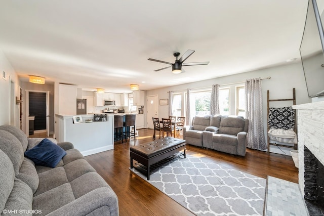 247 Tioga Ave, Bensenville, IL 60106 - living area with a stone fireplace, a ceiling fan, and dark wood-style floors