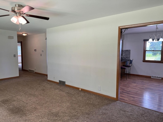 1536 Marberly Dr, Rockford, IL 61103 - carpeted spare room featuring healthy amount of natural light, a ceiling fan, and a chandelier
