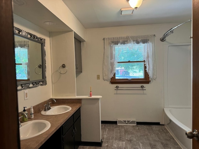 1536 Marberly Dr, Rockford, IL 61103 - bathroom with double vanity and shower / tub combination