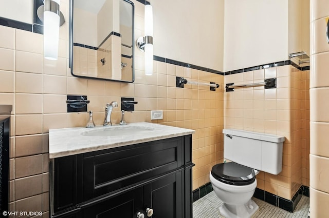 3900 N Keeler Ave, Chicago, IL 60641 - half bathroom featuring tile walls, vanity, tile patterned flooring, and a wainscoted wall