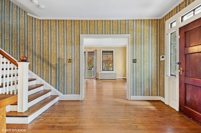 3900 N Keeler Ave, Chicago, IL 60641 - foyer entrance featuring stairs, wood finished floors, crown molding, and wallpapered walls