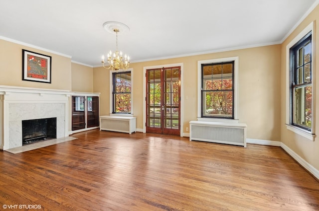 3900 N Keeler Ave, Chicago, IL 60641 - unfurnished living room with radiator heating unit, plenty of natural light, wood finished floors, and ornamental molding