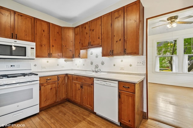 3900 N Keeler Ave, Chicago, IL 60641 - kitchen with white appliances, light wood-style flooring, decorative backsplash, and light countertops