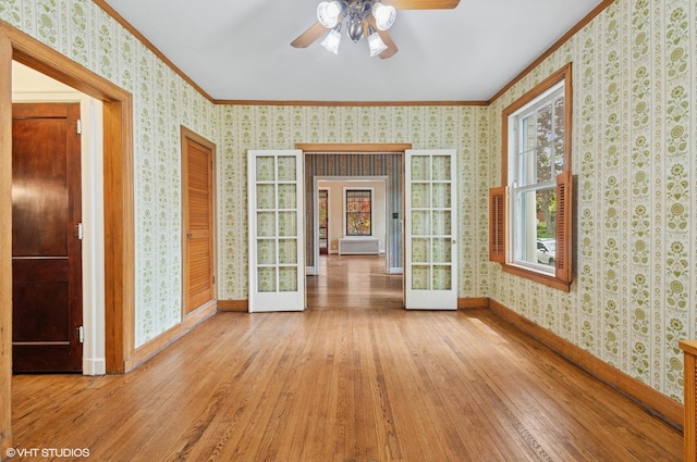 3900 N Keeler Ave, Chicago, IL 60641 - unfurnished room with crown molding, hardwood / wood-style floors, a ceiling fan, wallpapered walls, and radiator