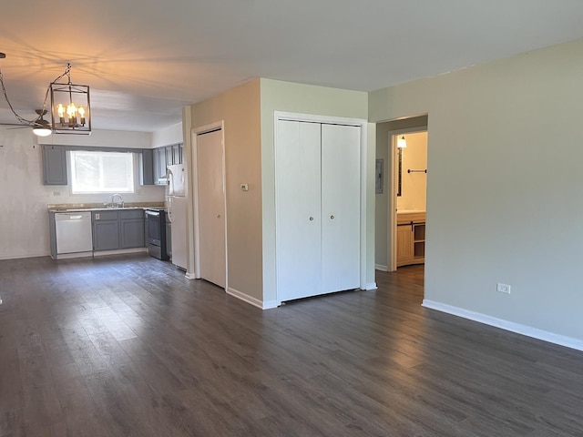 1208 Whispering Hills Ct Unit 1A, Naperville, IL 60540 - unfurnished living room featuring a chandelier and dark wood-type flooring