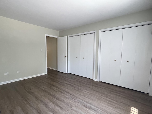 1208 Whispering Hills Ct Unit 1A, Naperville, IL 60540 - unfurnished bedroom featuring multiple closets and dark wood finished floors