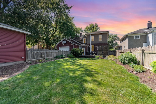 141 E Lincoln St, Seneca, IL 61360 - yard at dusk with a fenced backyard and an attached garage