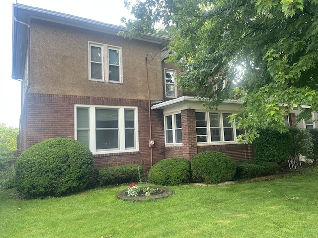 141 E Lincoln St, Seneca, IL 61360 - view of front facade with a front lawn, brick siding, and stucco siding