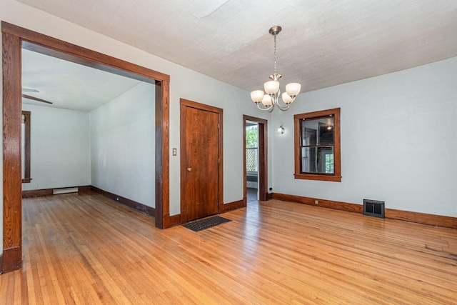 141 E Lincoln St, Seneca, IL 61360 - unfurnished room featuring light wood-type flooring and a chandelier