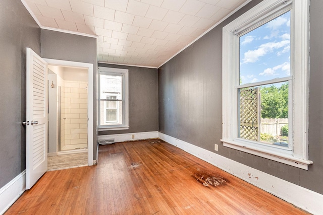141 E Lincoln St, Seneca, IL 61360 - unfurnished bedroom with crown molding and hardwood / wood-style flooring