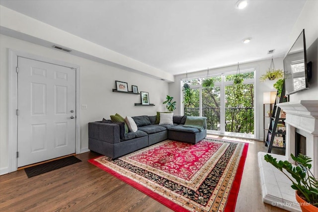 1124 W Diversey Pkwy Unit 2W, Chicago, IL 60614 - living area featuring wood finished floors, a fireplace with raised hearth, and recessed lighting