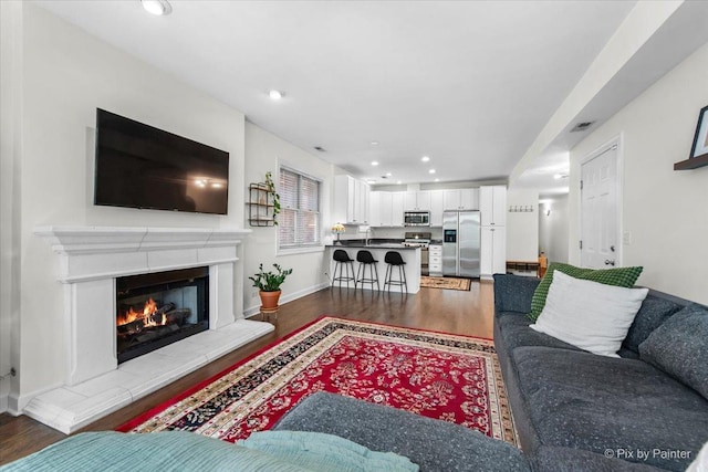 1124 W Diversey Pkwy Unit 2W, Chicago, IL 60614 - living area featuring wood finished floors, recessed lighting, and a glass covered fireplace