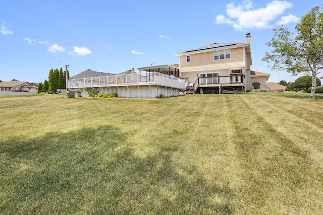 8425 Brookside Glen Dr, Tinley Park, IL 60487 - rear view of property with a deck, a chimney, roof mounted solar panels, and a yard