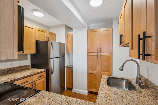 2909 N Sheridan Rd Unit 1309, Chicago, IL 60657 - kitchen with wood finished floors, light stone countertops, freestanding refrigerator, and stove
