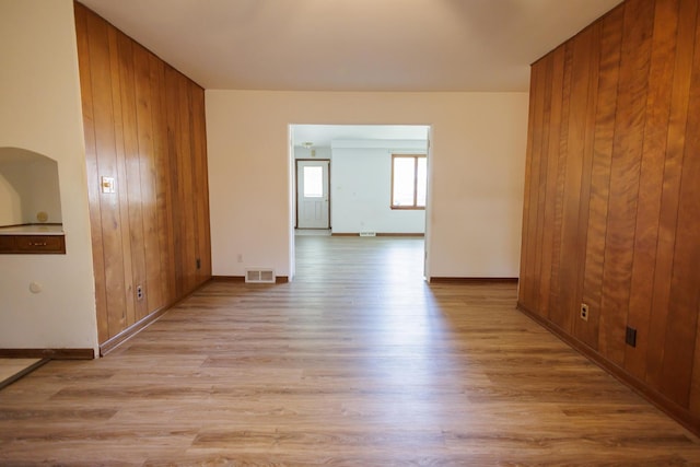 680 S Center Ave, Bradley, IL 60915 - spare room with light wood-type flooring and wood walls
