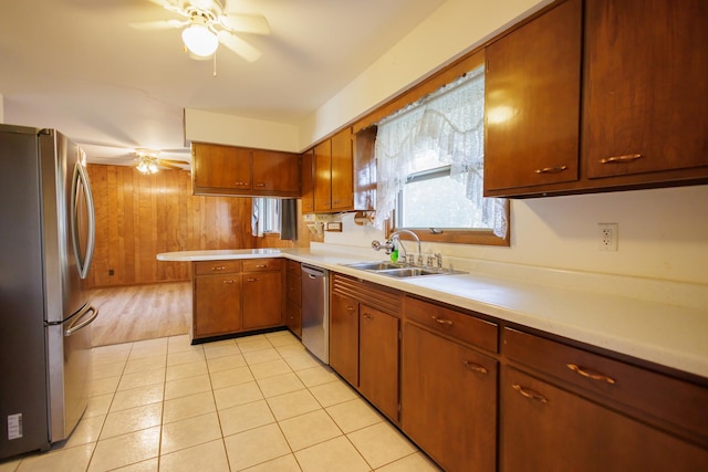 680 S Center Ave, Bradley, IL 60915 - kitchen with stainless steel appliances, a ceiling fan, a peninsula, light countertops, and wooden walls