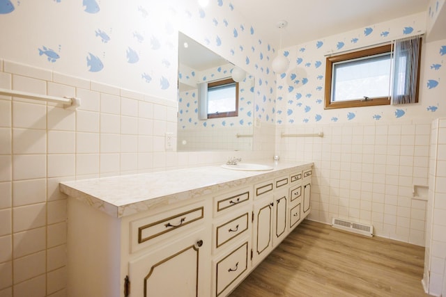 680 S Center Ave, Bradley, IL 60915 - bathroom featuring tile walls, vanity, wallpapered walls, a wainscoted wall, and wood finished floors