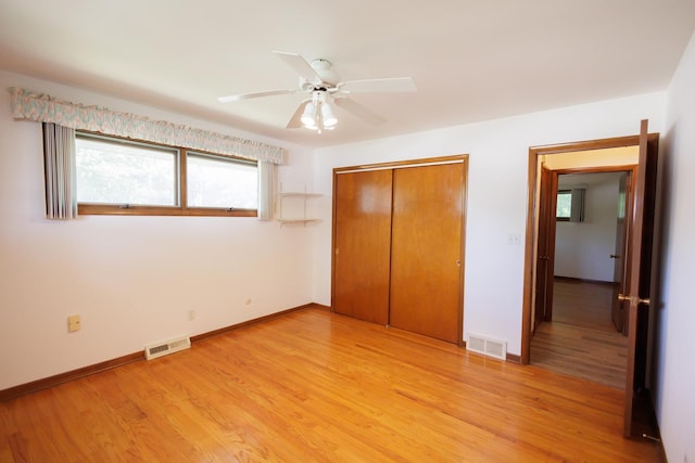 680 S Center Ave, Bradley, IL 60915 - unfurnished bedroom with a closet, light wood-style floors, and a ceiling fan
