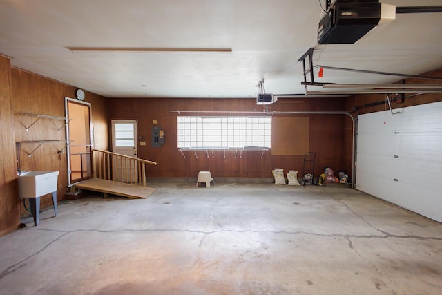 680 S Center Ave, Bradley, IL 60915 - garage featuring a garage door opener, wood walls, and electric panel