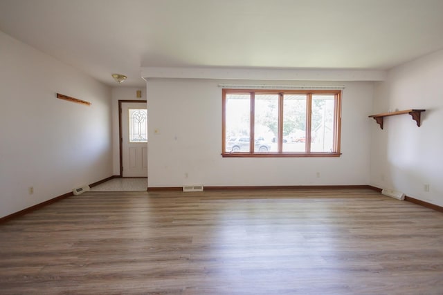 680 S Center Ave, Bradley, IL 60915 - unfurnished living room featuring wood finished floors and baseboards