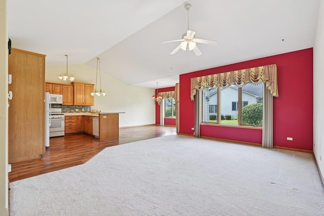 757 Bauman St Unit 0, Marengo, IL 60152 - kitchen featuring white appliances, a chandelier, carpet floors, lofted ceiling, and open floor plan
