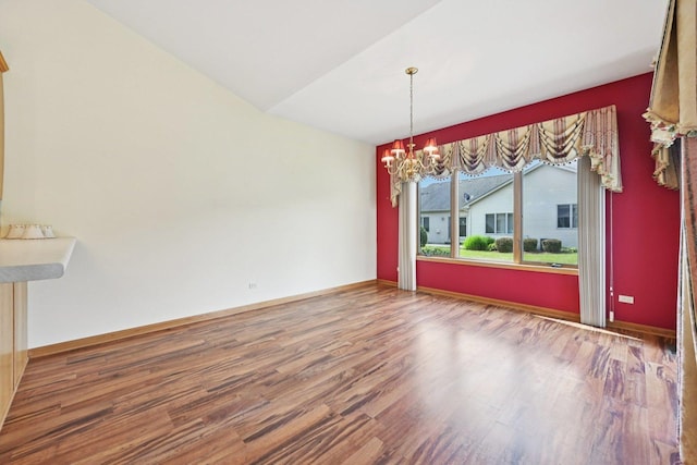 757 Bauman St Unit 0, Marengo, IL 60152 - unfurnished dining area featuring a chandelier, wood finished floors, and vaulted ceiling