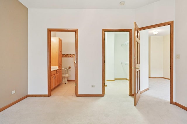 757 Bauman St Unit 0, Marengo, IL 60152 - unfurnished bedroom with light colored carpet, a spacious closet, and ensuite bathroom