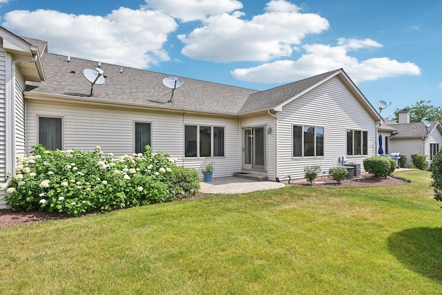 757 Bauman St Unit 0, Marengo, IL 60152 - rear view of property with a patio area, a yard, and a shingled roof