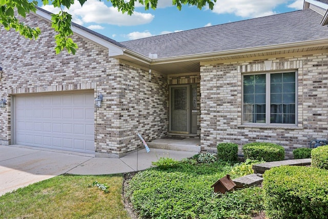 757 Bauman St Unit 0, Marengo, IL 60152 - property entrance featuring a garage, a shingled roof, and brick siding