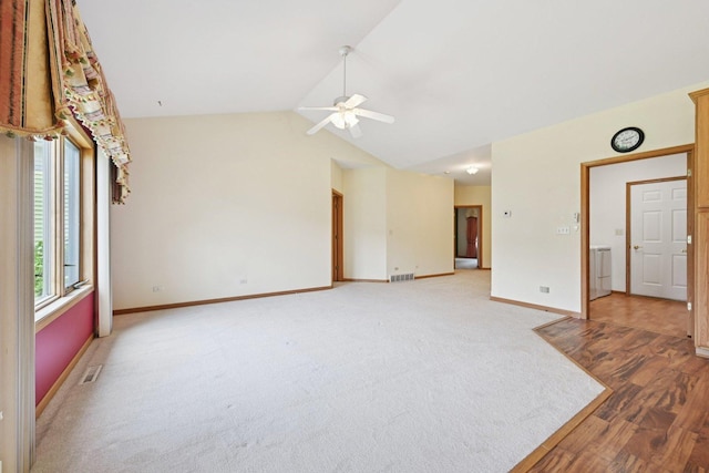 757 Bauman St Unit 0, Marengo, IL 60152 - empty room featuring a ceiling fan, vaulted ceiling, light wood-style flooring, washer / clothes dryer, and light colored carpet