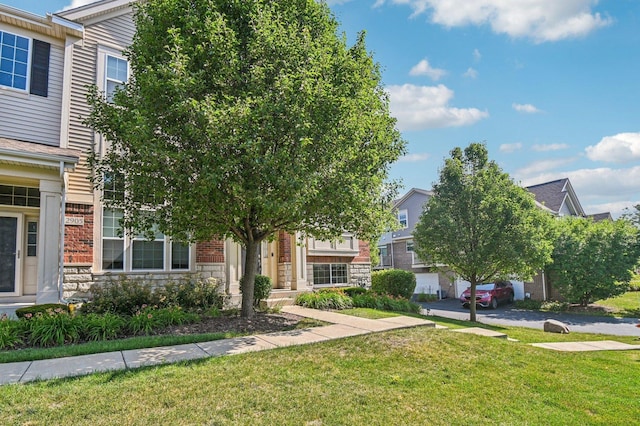 2903 Henley Ln, Naperville, IL 60540 - obstructed view of property featuring stone siding and a front lawn