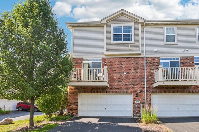 2903 Henley Ln, Naperville, IL 60540 - view of front of house featuring brick siding, a garage, driveway, and a balcony