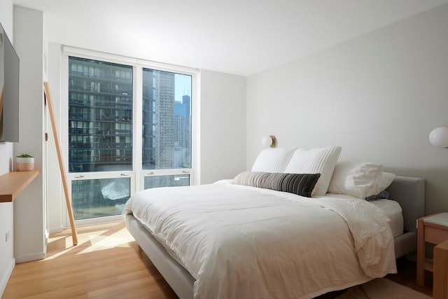 2 E Erie St Unit 2702, Chicago, IL 60611 - bedroom with light wood-style floors and a view of city