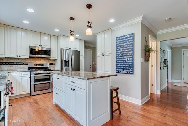 985 W Bauer Rd, Naperville, IL 60563 - kitchen featuring stainless steel appliances, backsplash, ornamental molding, light wood-style flooring, and light stone countertops