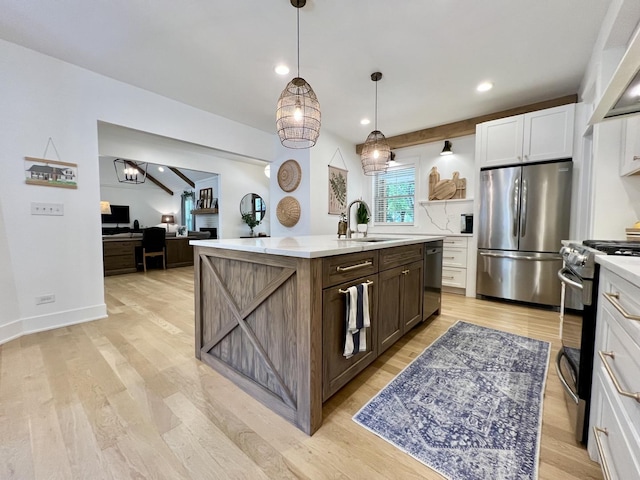 204 Country Commons Rd, Trout Valley, IL 60013 - kitchen featuring stainless steel appliances, light countertops, a center island with sink, white cabinetry, and light wood-style flooring