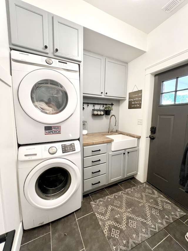 204 Country Commons Rd, Trout Valley, IL 60013 - laundry room with stacked washer and clothes dryer, cabinet space, and dark tile patterned floors