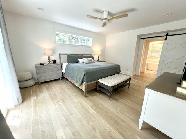 204 Country Commons Rd, Trout Valley, IL 60013 - bedroom with a barn door, light wood-style floors, and a ceiling fan