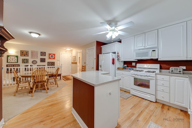 1538 Queen Ann Ln, Gurnee, IL 60031 - kitchen with white appliances, light countertops, light wood finished floors, and white cabinetry